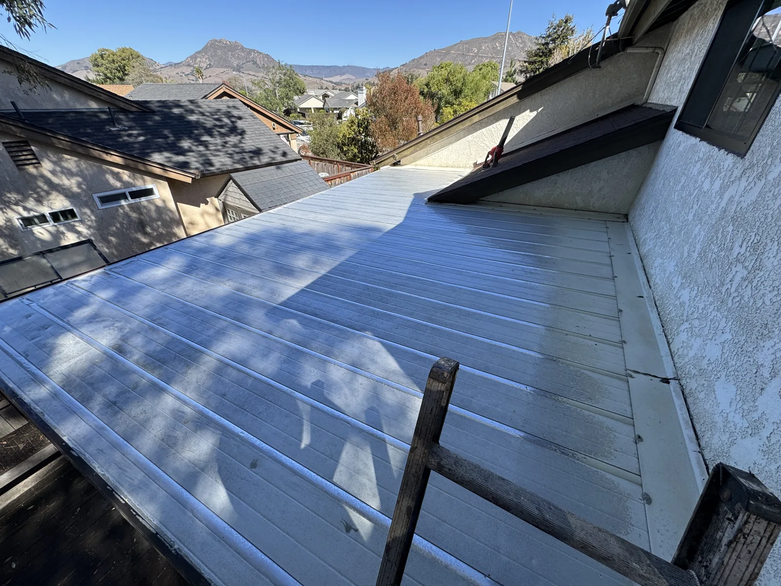 Sunroom roof after cleaning, with holes and problem areas patched and reinforced