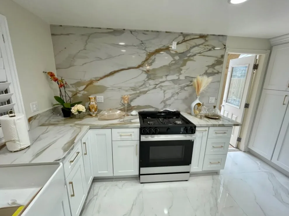Gas cooktop set into stone countertops with marble backsplash in a San Luis Obispo kitchen remodel