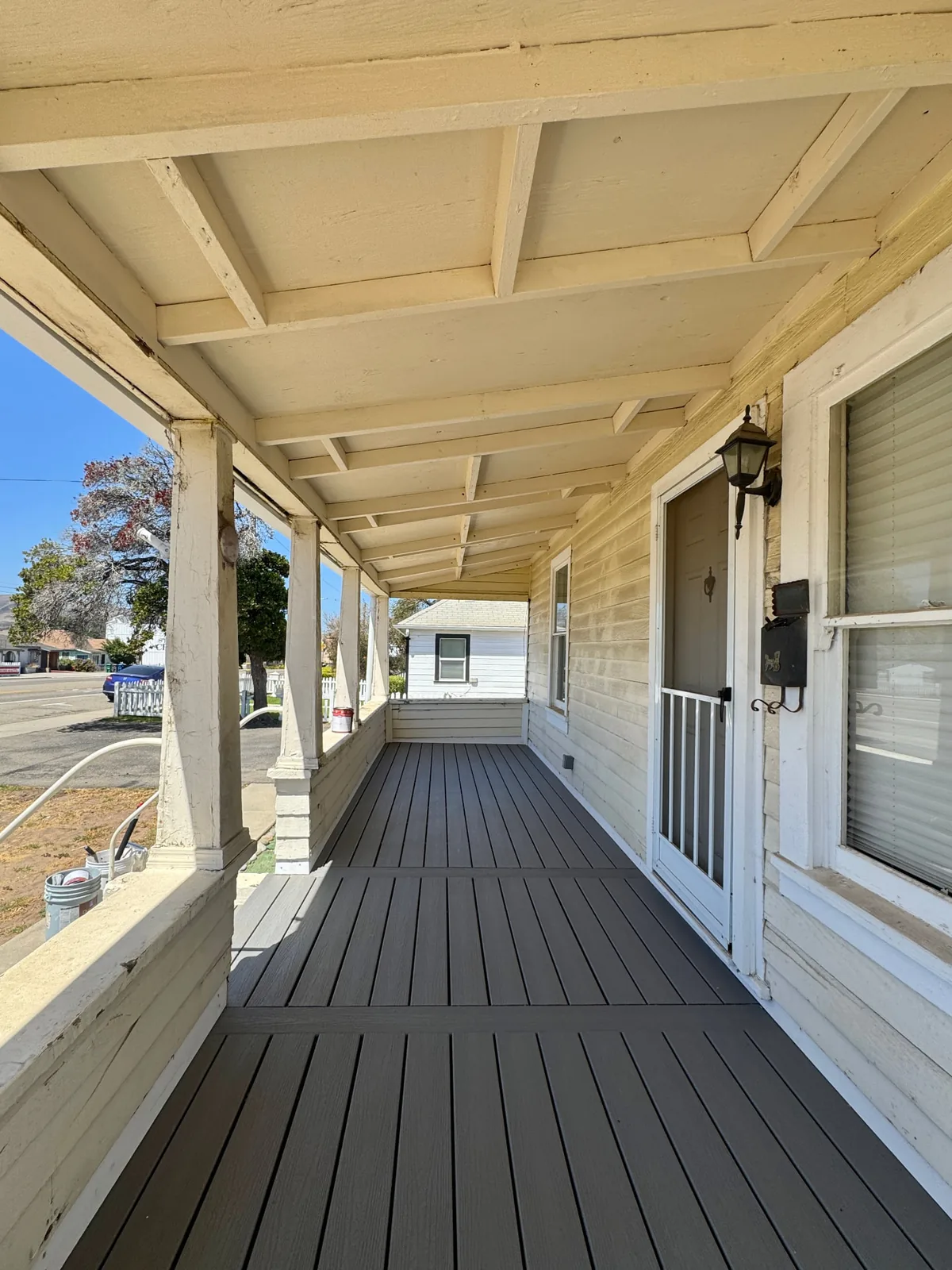 Finished gray Trex deck on a covered front porch in Santa Maria by Mau & Co
