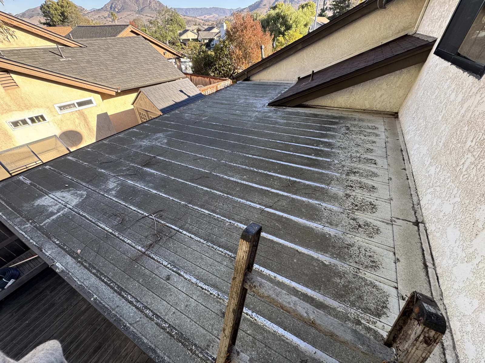 Attached sunroom roof in the San Luis Obispo area before work, covered in dirt and grime