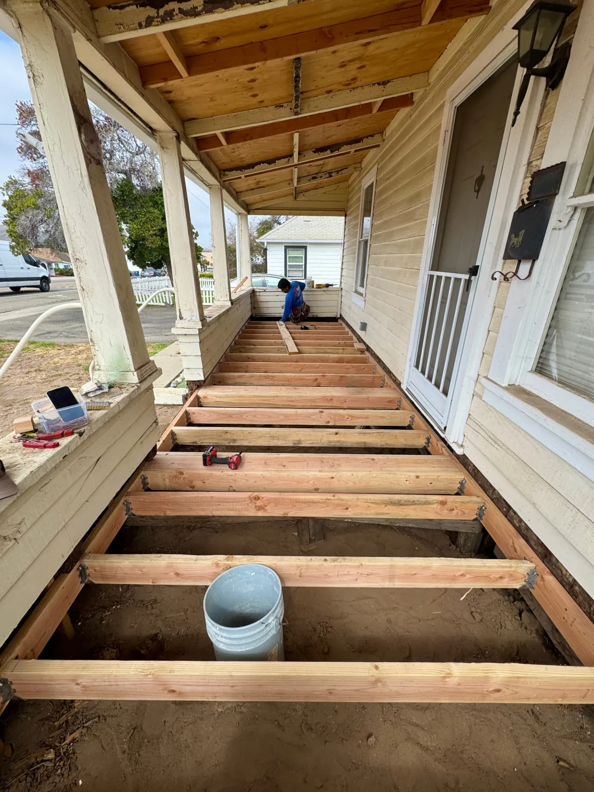 Framer installing new deck joists during a front porch rebuild in Santa Maria