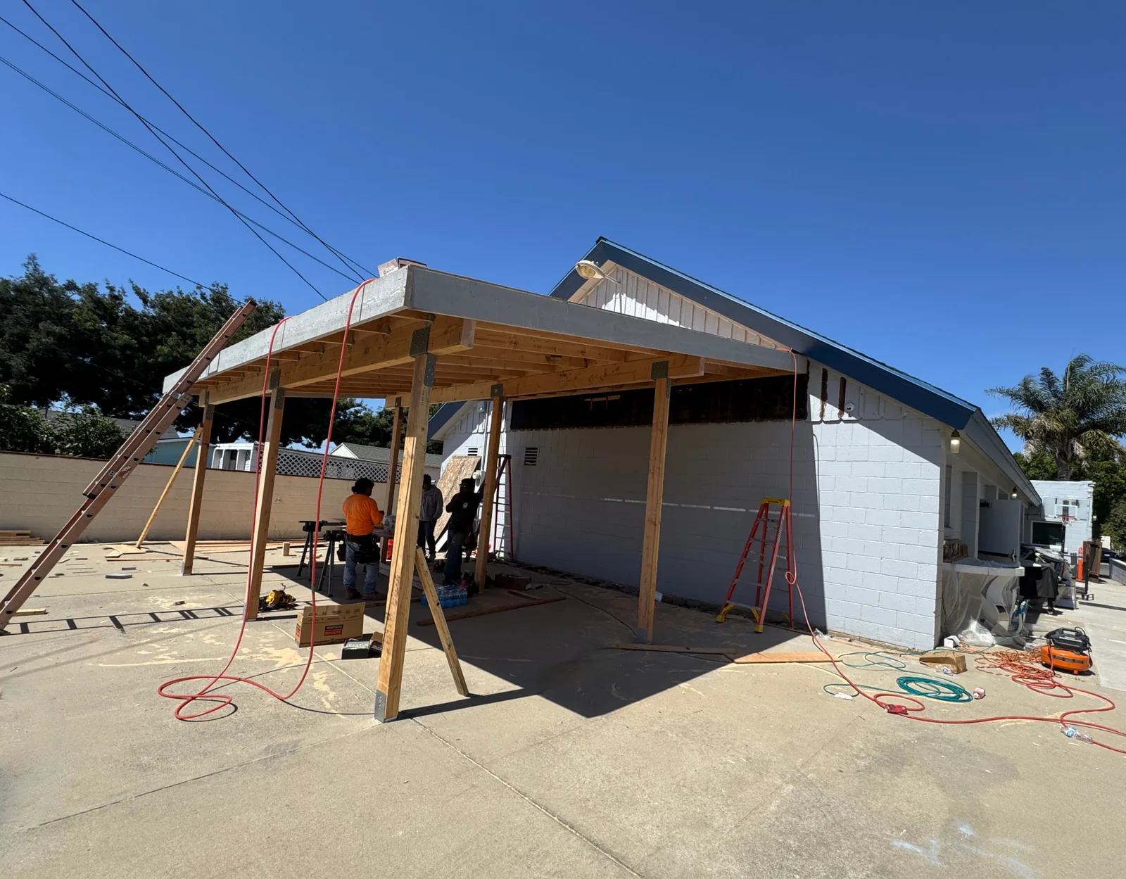 New posts and beam framing under construction on an attached church carport in Santa Maria